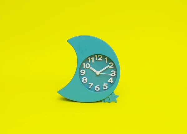 Clock isolated on the yellow — Stock Photo, Image