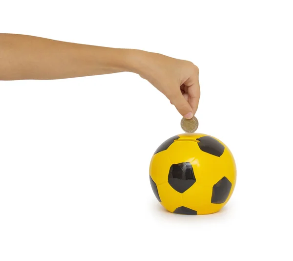 Closeup of woman's hand inserting coin in moneybox — Stock Photo, Image