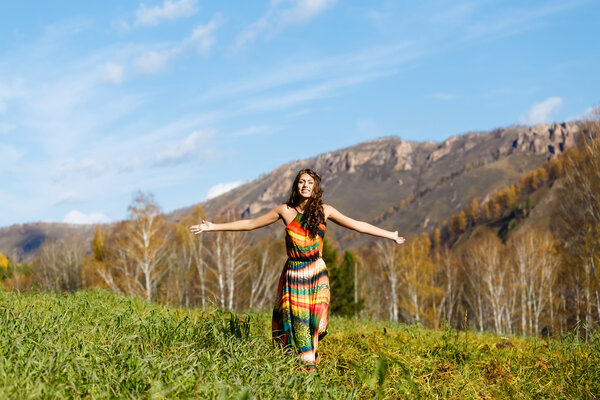 happy young woman in the autumn wood of the mountain