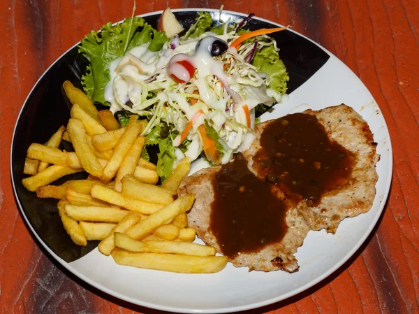 Fried potato, pork, salad on  plate — Stock Photo, Image