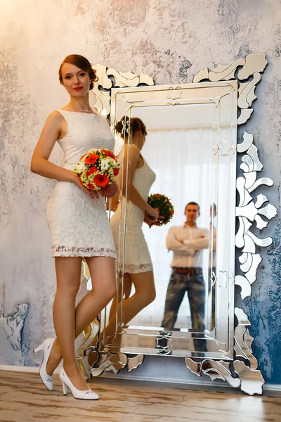 Man and the woman - the groom and the bride in the room with a m — Stock Photo, Image