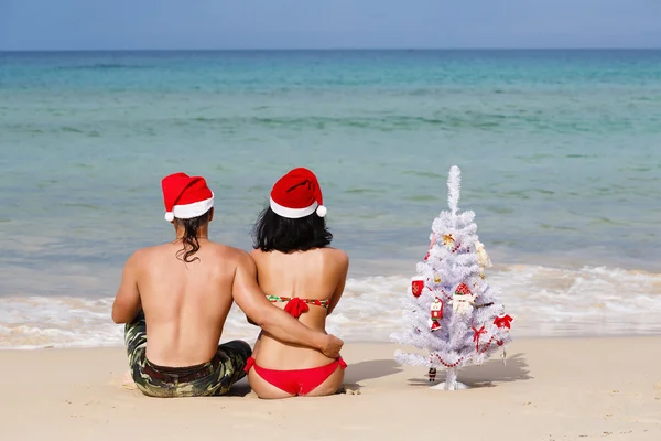 Miłości para w sukience z sob Mikołaj na plaży — Zdjęcie stockowe