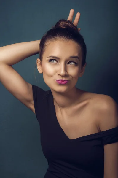 Portrait of funny girl showing horn — Stock Photo, Image