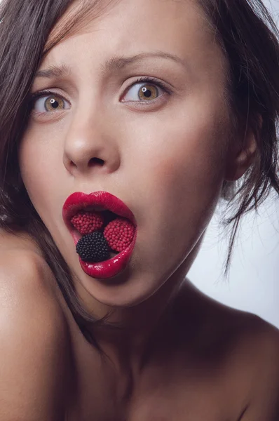 Girl with a candy in the mouth — Stock Photo, Image