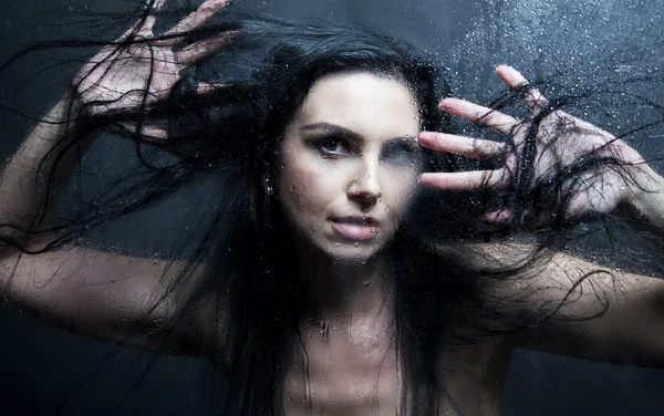 Hand av ung kvinna melankoli och ledsen vid fönstret i regnet Stockfoto