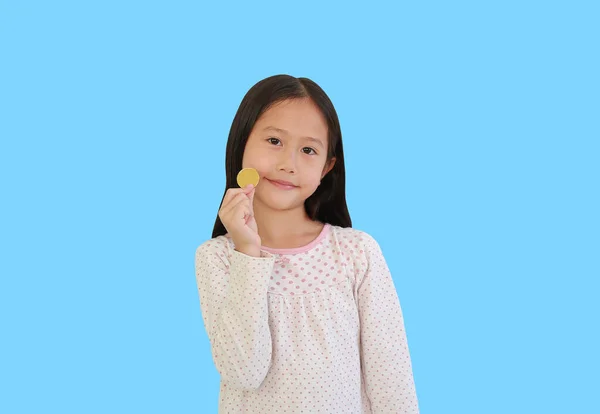 Portrét Asijské Holčičky Ukazuje Zlatou Minci Izolované Světle Modrém Pozadí — Stock fotografie