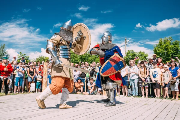 Knights In Fight With Swords. Restoration Of Knightly Battle