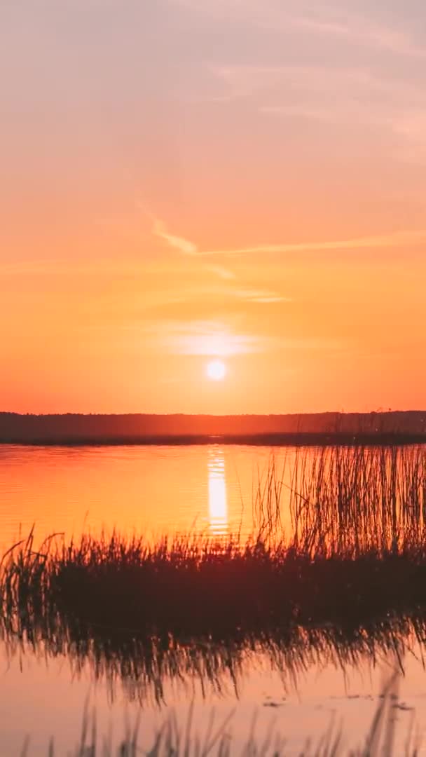 Verticale opname 4K Sundown Above Lake River Horizon bij zonsondergang. Natuurlijke lucht in warme kleuren Water. Zonnewateren. Time-Lapse Time Lapse bij zonsopgang — Stockvideo