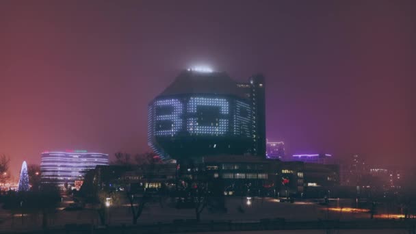 Minsk, Belarus - December 15, 2020: National Library Building In Misty Evening Night. Famous Landmark — Stock Video