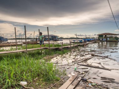 Tabatinga, Brazil - Dec 09, 2017: Pollution in the port of Amazon river, during the low water. clipart