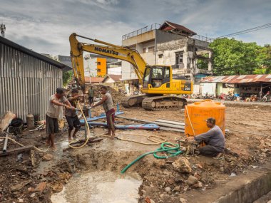 Ambon, Endonezya - 17 Şubat 2018: Ambon caddesinde su pompalayan işçiler.