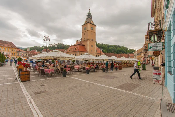 The renovated market square. Flock of Tourists walking on the main square of the city
