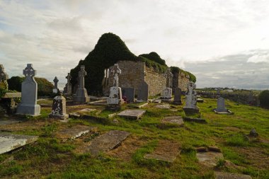 The ruins of the medieval church of Kilmacreehy or Kilmacrehy  are located at Liscannor in the south of County Clare in Ireland by the sea. clipart