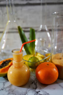 Ananas limonlu papaya portakallı tropik kokteyl. Laboratuvarda renkli kokteyller servis ediliyor.