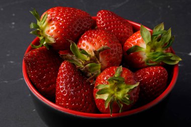 Kırmızı kasede taze çilek. 