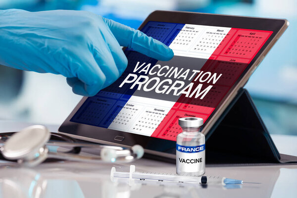Professional working in calendar of vaccines plan for France nation, Immunization concept. Working with tablet in the program of the vaccination schedule for France. Photomontage with 3d illustration