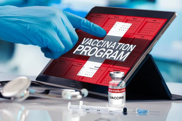 Professional working in calendar of vaccines plan for Switzerland nation, Immunization concept. Working with tablet in the program of the vaccination schedule for Switzerland. Photomontage with 3d illustration