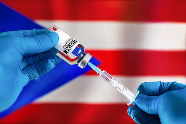 Doctor preparing vial of vaccine injection for the vaccination plan against diseases in Puerto Rico. Injecting dose of vaccine in syringe for infections prevention in front of the Puerto Rico flag