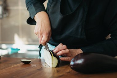 Şefin patlıcan keserken yakın plan fotoğrafı.