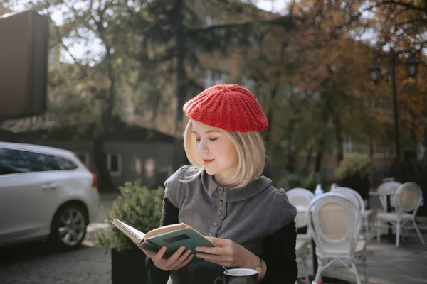 年轻女人带着贝雷帽在咖啡店看书 法国街头风格 — 图库照片