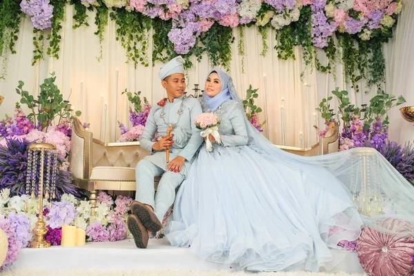 Indoor shooting for Malay wedding, the bride and groom wearing Malay traditional  cloth in marriage ceremony . Happy & Family Concept