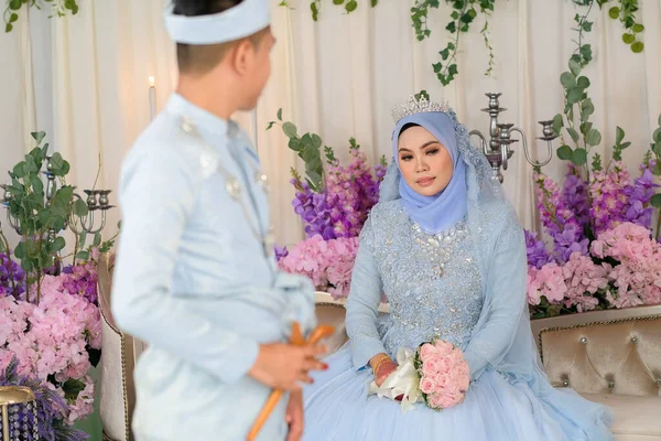 Indoor shooting for Malay wedding, the bride and groom wearing Malay traditional  cloth in marriage ceremony . Happy & Family Concept