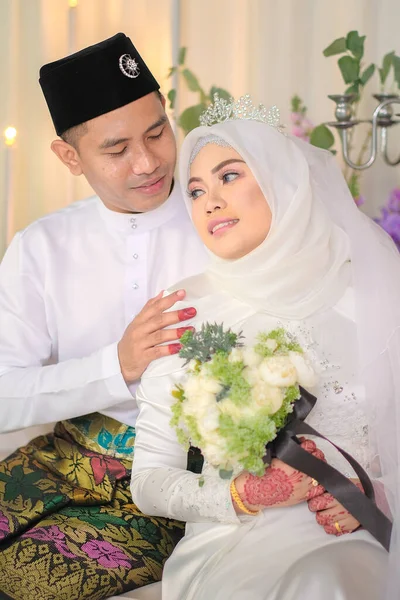 Indoor shooting for Malay wedding, the bride and groom wearing Malay traditional  cloth in marriage ceremony . Happy & Family Concept