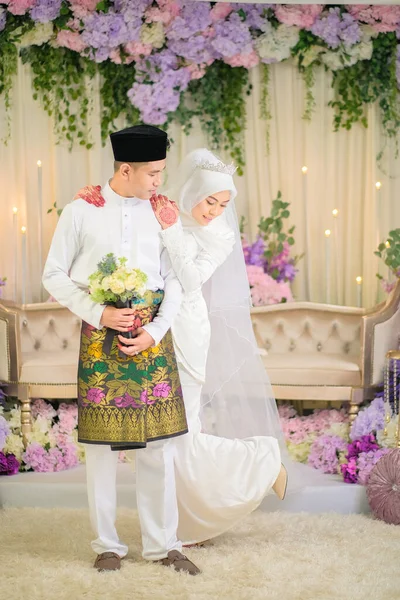 Indoor shooting for Malay wedding, the bride and groom wearing Malay traditional  cloth in marriage ceremony . Happy & Family Concept