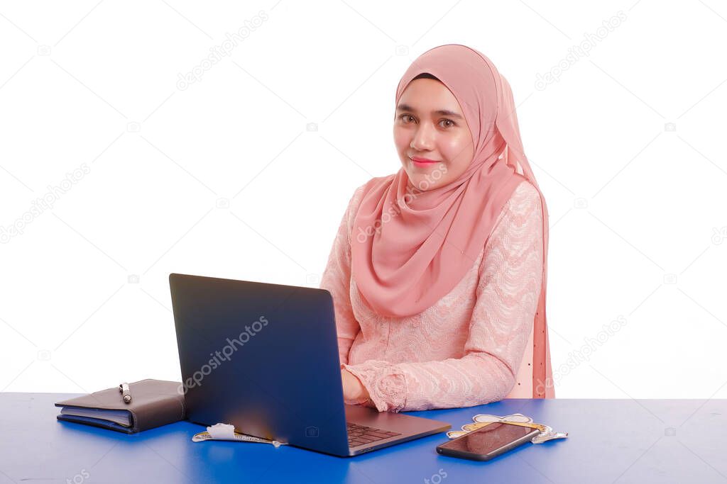 Pretty young  woman wearing hijab in front of laptop search and doing office work with different face expression isolated in white background - office, business, finance and work station concept .