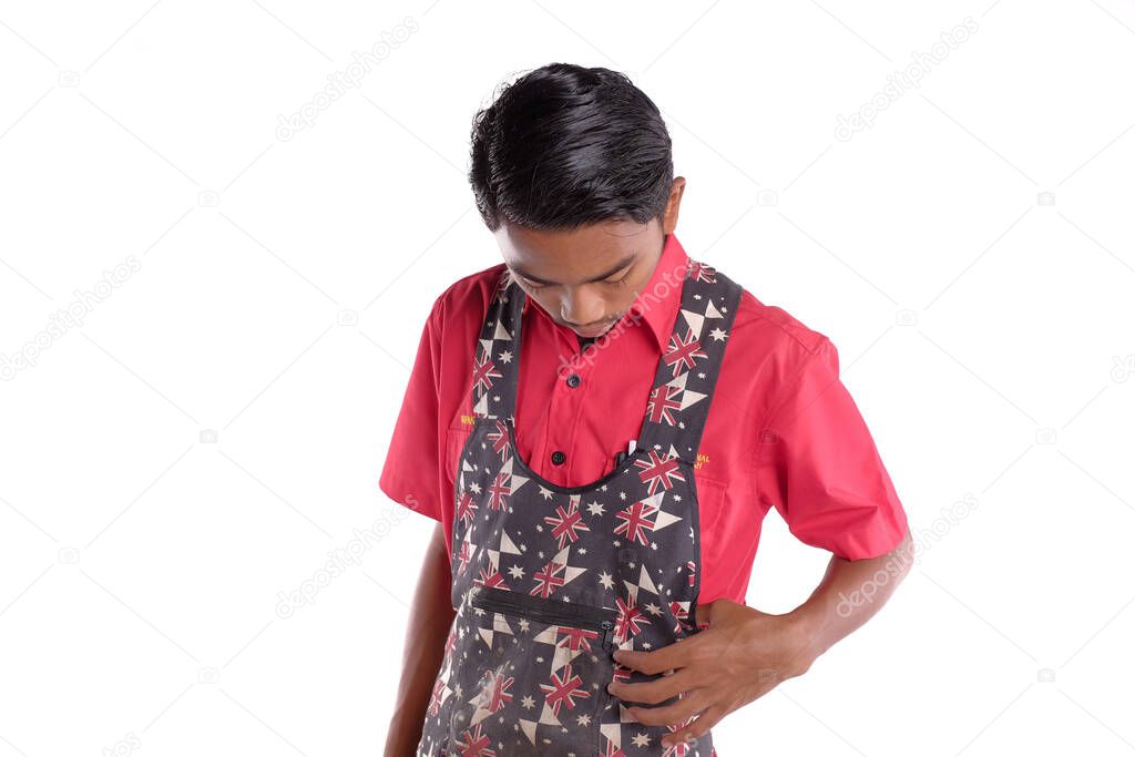 Portrait of confident young carpenter wearing apron isolated on white background