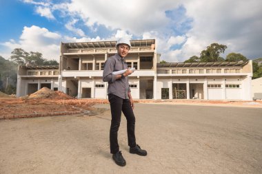 İnşaat alanındaki belgelerle çalışan başarılı inşaat mühendisi.