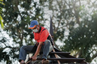 Marangoz yeni bir teras inşaatı projesinde çatı yapısının kurulumunu yapıyor