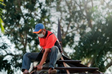 Marangoz yeni bir teras inşaatı projesinde çatı yapısının kurulumunu yapıyor