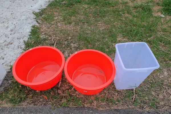 Water storage in a large plastic container because of a water supply disruption. River pollution issue.