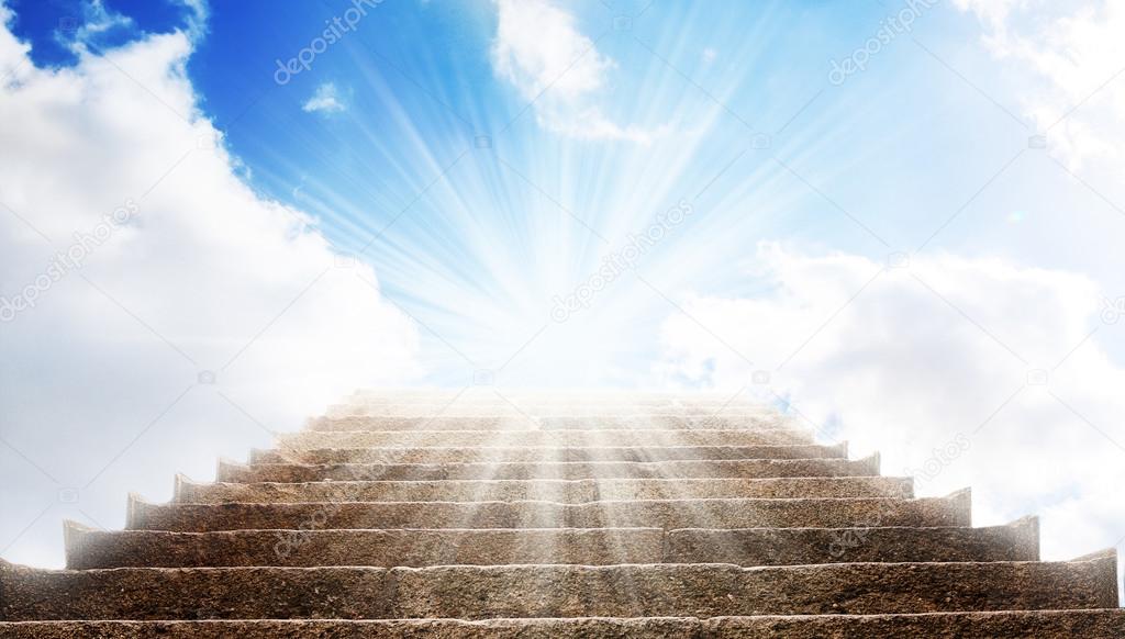 A stone stair in the way up to blue sky, there is a strong light in the end of the way
