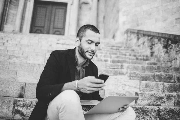 Portrait of young bearded man talking on his phone — Stock Photo, Image