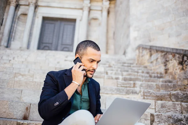 Portrait of young bearded man talking on his phone — Stock Photo, Image