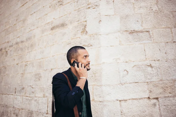 Portrait of young bearded man talking on his phone — Stock Photo, Image