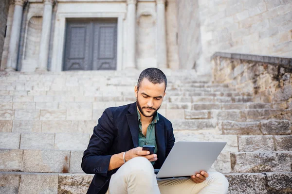 Portrait of young bearded man talking on his phone — Stock Photo, Image