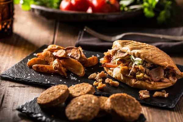 Doner kebab with fried potato on table — Stock Photo, Image