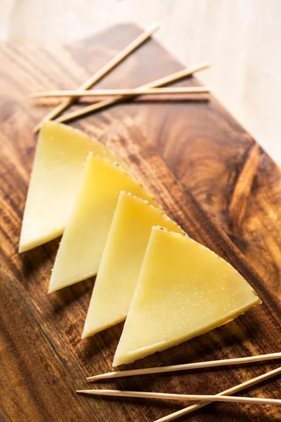 Slices of spanish cheese — Stock Photo, Image