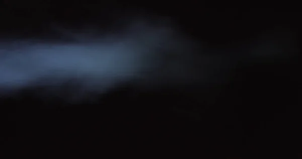 Atmospheric smoke 4K Fog effect. Smoke in slow motion on black background. White smoke slowly floating through space against black background