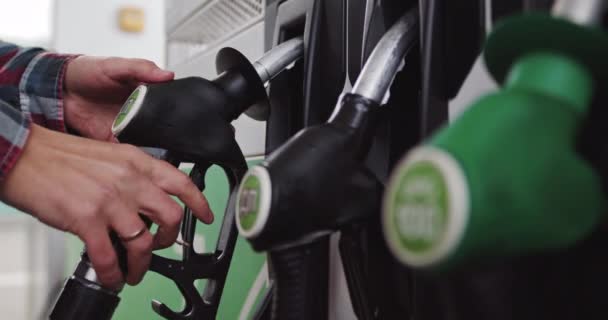 Close up of hand and fuel nozzle. Fuel nozzle getting put into its place. Fuel, gas station, petrol prices concept. Gasoline, gas, fuel, petroleum concept. Translation: Diesel — Stock Video
