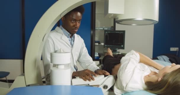 Літотрипсія для нирок і уретеральних каменів у сучасному центрі. Лікар - професіонал африканський чоловік за допомогою ультразвукового сканування визначає положення каменів перед літотрипсією. — стокове відео