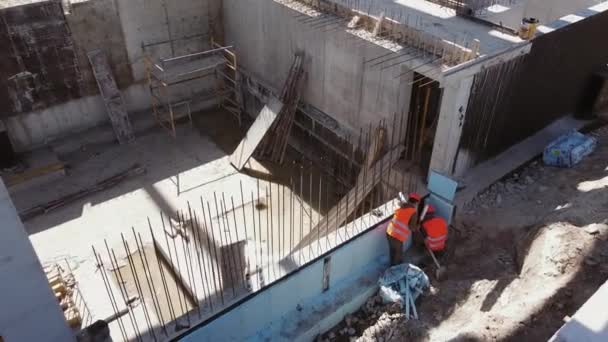 Construction Industry, Monolithic Frame Technology. Top View Of Employees Being Busy With Construction Works. Builders Insulate The Foundation With Foam. Work With Reinforced Concrete Structures — Stock Video