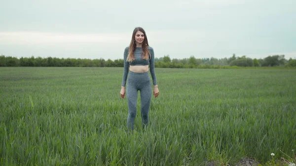 Beautiful fitness model butt workout outdoors. Professional Female Athlete Training Outdoors, Doing Jumping Squats to Strengthen Legs and Abs Muscles. Sporty woman squats workout.