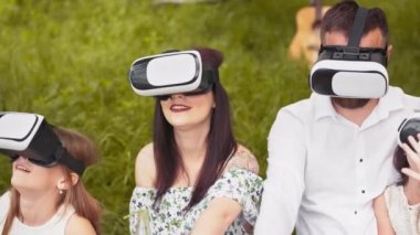 Portrait of happy family using vr glasses in living room in slow motion. Shot with RED camera in 8K. Concept of innovation technology, family entertainment, game. Parents with two kids using VR