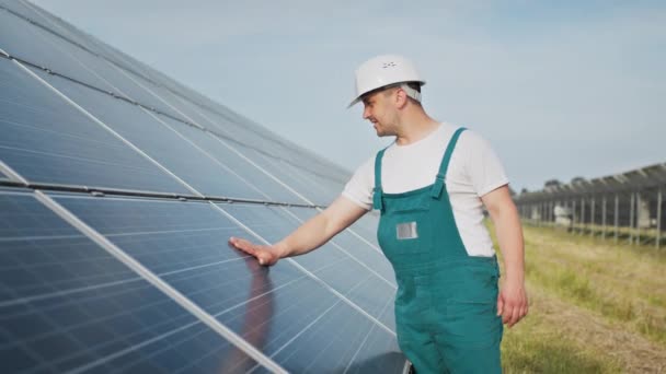 Engineer expert in solar energy photovoltaic panels. Man in hard helmet examining object. Concept of solar station development and green energy. Technology. Ecological concept. — Stock Video
