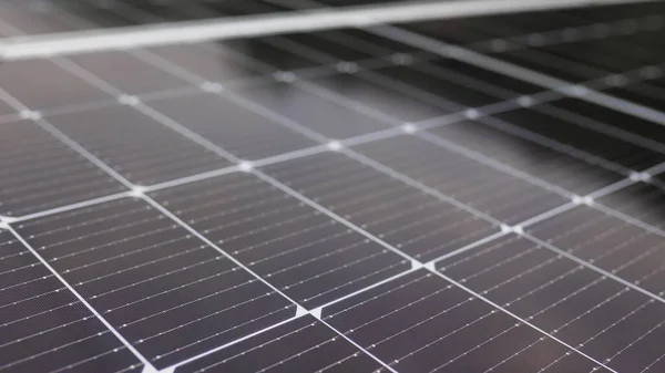 Close-up of modern photovoltaic solar battery panels. Rows of sustainable energy solar panels installed on terrace. Solar panels on roof top. Panels at home. Photovoltaic solar panel extreme close up