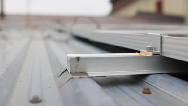 Κοντινό πλάνο της τοποθέτησης του ηλιακού πάνελ, εγκατάσταση ηλιακών συλλεκτών στην οροφή του σπιτιού. Στερέωση και σύνδεση σύγχρονων ηλιακών συλλεκτών. Γραμμές της βιώσιμης ενέργειας ηλιακούς συλλέκτες εγκατασταθεί στη βεράντα. — Αρχείο Βίντεο